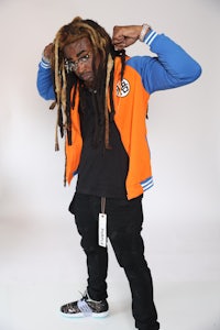 a man with dreadlocks is posing for a photo